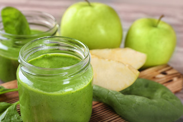 Jar of spinach smoothie on table