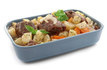 Blue casserole with tasty meat and potatoes on white background