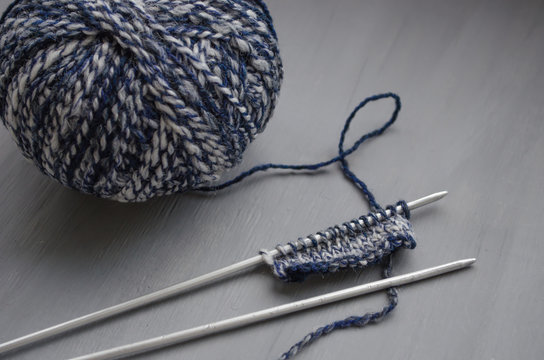 Woolen melange yarn and knitted pattern on knitting needles