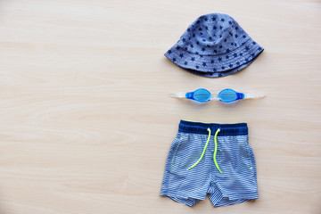 Summer accessories on wooden background. Holiday concept