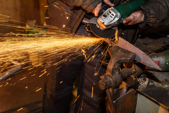 Blacksmith, knife sharpening, sparks, metal.