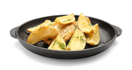 Frying pan with delicious baked potato wedges on white background