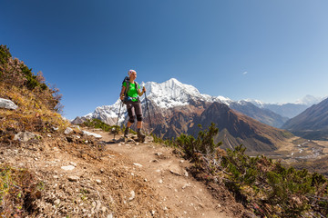 Fototapeta premium Hiker is climbig to Manaslu base camp in highlands of Himalayas on Manaslu circuit