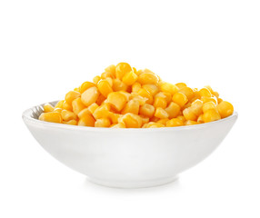 Bowl with canned corn kernels on white background