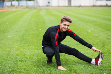 Fototapeta premium Young caucasian boy training outdoor. Sport and muscle concept