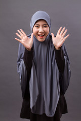 exited, surprised, happy, laughing muslim woman with hijab or head scarf