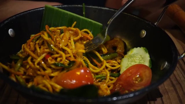 Use Folk Eating Fried Mamak Mee Goreng Or Fried Yellow Noodle Malay Style In Black Pan At Restaurant