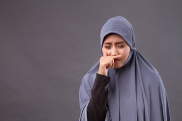 muslim woman catching a cold, runny nose