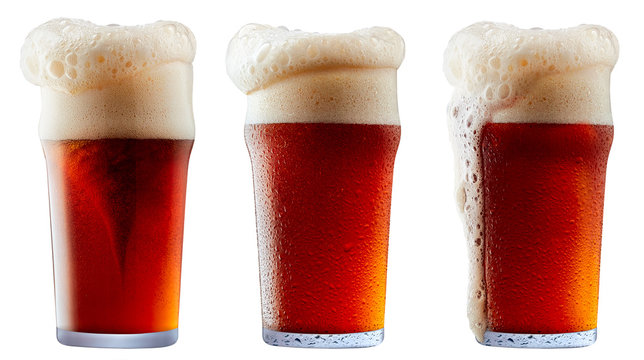 Mug of frosty dark red beer with foam isolated on a white background