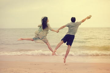 Lovely couple having fun on the beach outdoors background. Back view of healthy people, excitement and amazement emotional freedom leisure. Travel vacation attractive enjoyment lifestyle.
