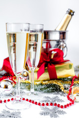 glasses of champagne and Christmas ornaments on white background