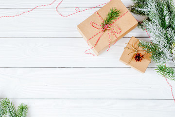 gifts boxes with fir branches on wooden background top view