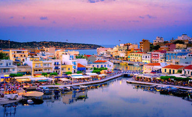 The lake Voulismeni in Agios Nikolaos,  a picturesque coastal town with colorful buildings around the port in the eastern part of the island Crete, Greece - obrazy, fototapety, plakaty