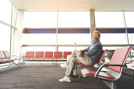 Joyous smiling elder man locating in airport