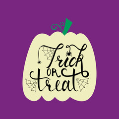 Trick or treat modern brush inscription on pumpkin. Illustrated phrase for Halloween.