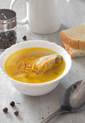 Chicken soup in plate on white table. Selective focus