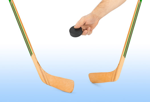 Ice hockey stick and hand with puck