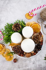 Christmas composition with candles, nuts and cinnamon sticks. Copy space