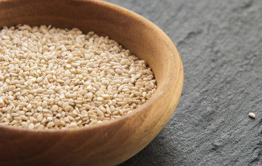 Sesam seeds in a little bowl wooden Natural light. Selective focus.