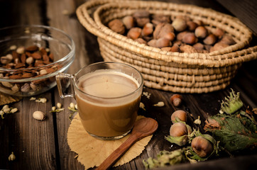 Healthy snack on rustic table indoors on autumn. Almonds and pistachio in bowl.