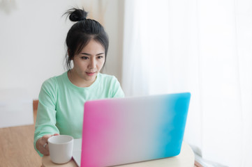 Fototapeta premium Young Asian woman using laptop computer