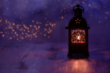 Lantern with candle on a beautiful blue background with stars. Christmas background .
