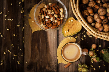 Fototapeta na wymiar Healthy snack on rustic table indoors on autumn. Almonds and pistachio in bowl.