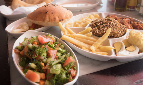 Selection of Middle East food: vegetables, falafel and salads