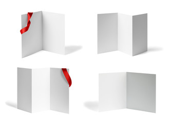 close up of a  blank folded leaflet or a desktop calendar with ribbon on white background 