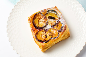 Homemade plum fruit pie slice on a plate