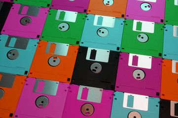 Multicolored floppy disc 3.5 for old computers. Aligned as background.