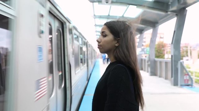 Girl waiting for train and smiling, slow motion