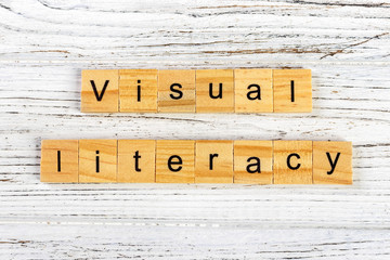 visual literacy word made with wooden blocks concept