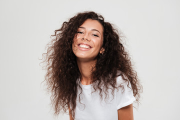 Portrait of a young pretty girl with long curly hair