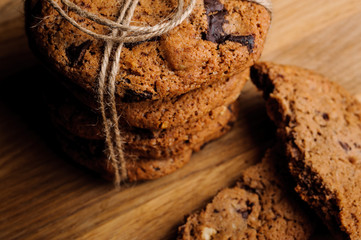 Group of oatmeal cookies with chocolate on wooden table