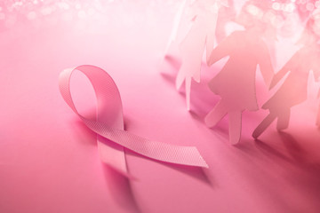 The Sweet pink ribbon shape with girl paper doll on pink background  for Breast Cancer Awareness...