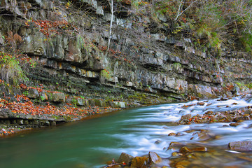 Rocky shore of river in autumn time.