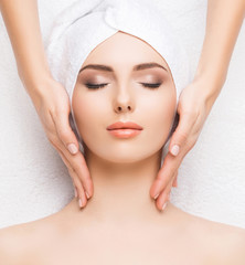 Woman getting face massage treatment. Person in spa. Healthcare, healing, and medicine concept.