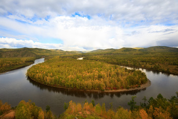 beautiful autumn landscape with river and forest under blue sky