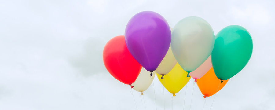 Lots of colorful balloons on the blue sky, concept of love in summer and valentine, wedding honeymoon - Panoramic banner. Vintage effect style pictures.
