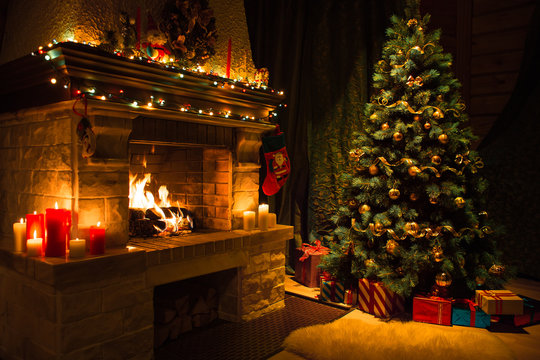 Living room interior with decorated fireplace and christmas tree