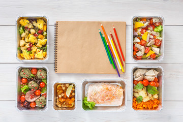 Healthy food take away in boxes, top view at wood