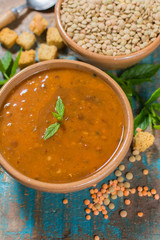 Homemade red lentils soup in yellow bowl