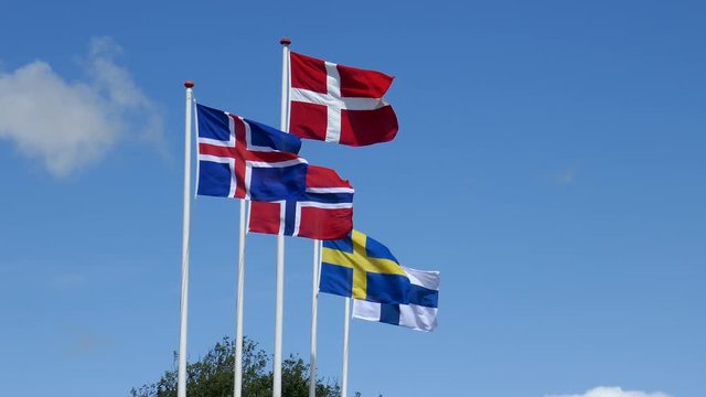 Skandinavien Fahnen von Norwegen, D&auml;nemark, Schweden, Island, Finnland im Wind vor blauen Himmel