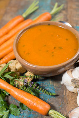 Spicy carrot soup with harissa made from hot chili pepper, lemon, garlic, coriander.