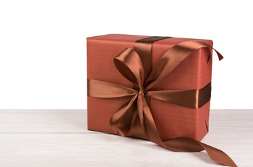 Christmas holiday gift box wrapped in paper on white wood