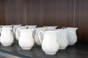Fototapeta na wymiar The beautiful white ceramic milk jug.