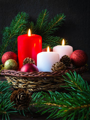 Christmas red balls, candles, spruce branches, wreath and snowflakes on a dark background Decoration for a New Year's holiday with a copy space