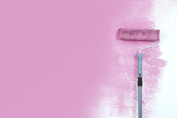 paint roller next to the pink wall.