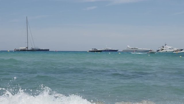  French coast Pampelonne beach sea water with yachts and people